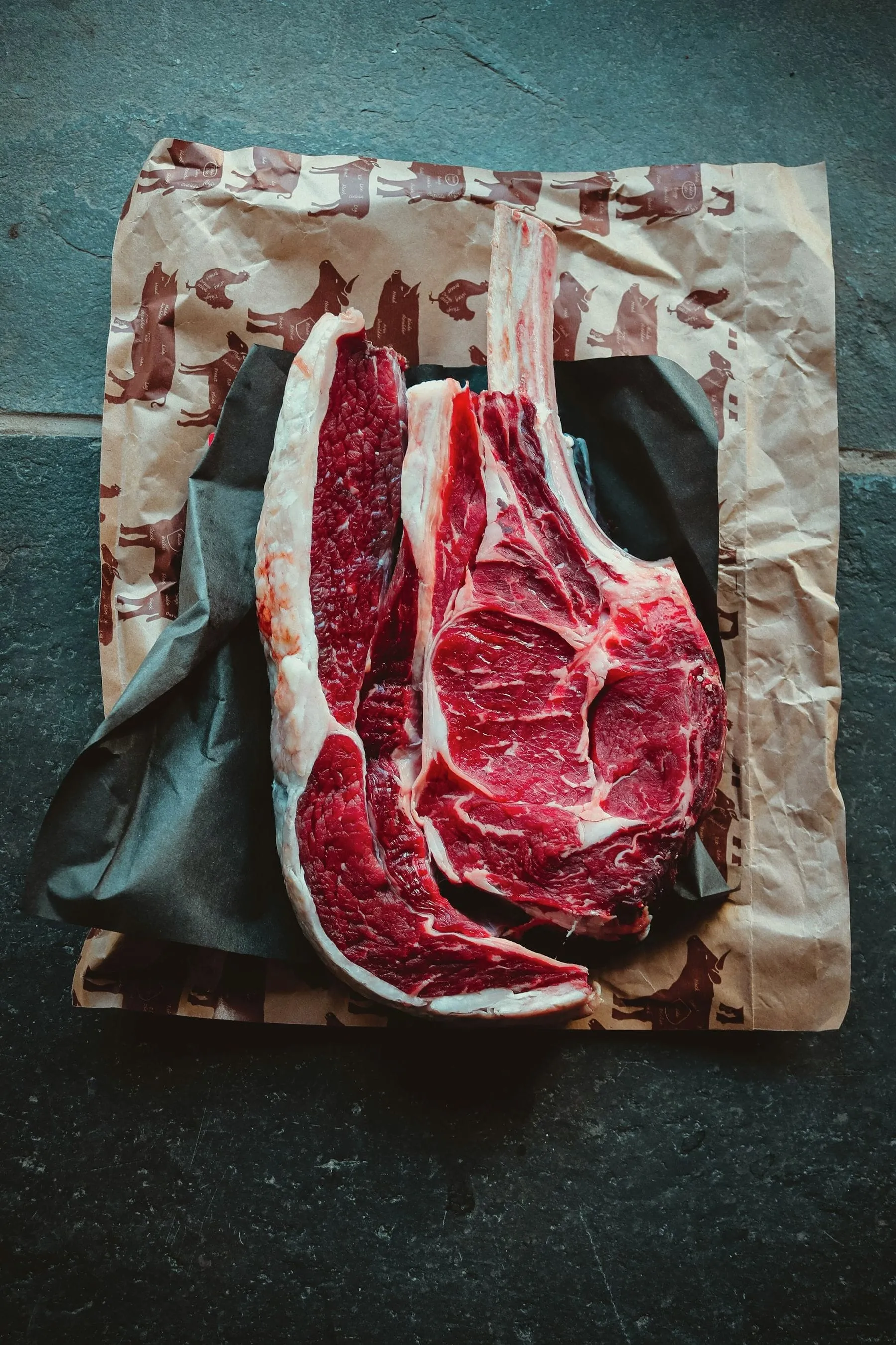 A butcher at Perry Butcher Co. in Waterboro, Maine holding a bone-in beef rib roast