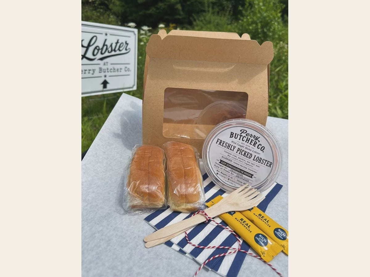 Perry Butcher Co. Lobster Roll Kit — the kraft carrier box with a labeled tub of freshly picked Maine lobster meat, two brioche buns, mayonnaise and wooden utensils
